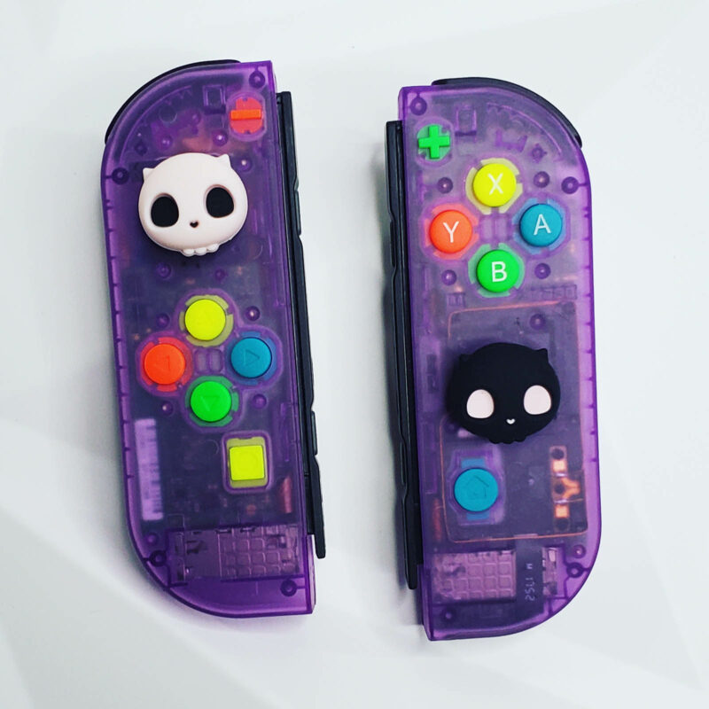 Clear Atomic Purple Joycons with Spewpy Caps made by KILLSCREEN