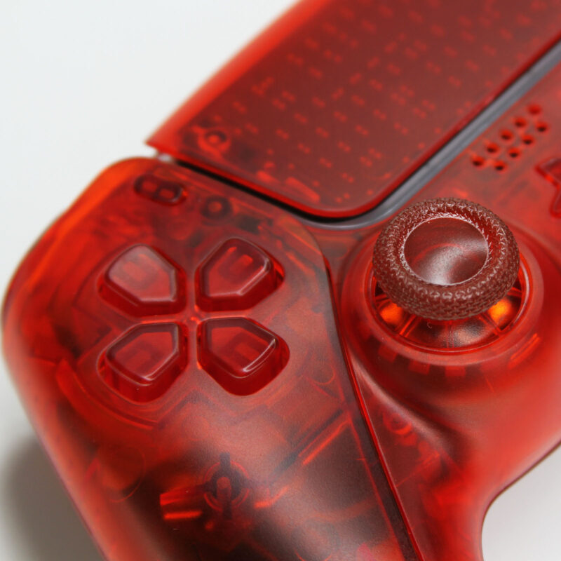 Close-up view of d-pad of Triple Clear Red PS5 Controller by Killscreen