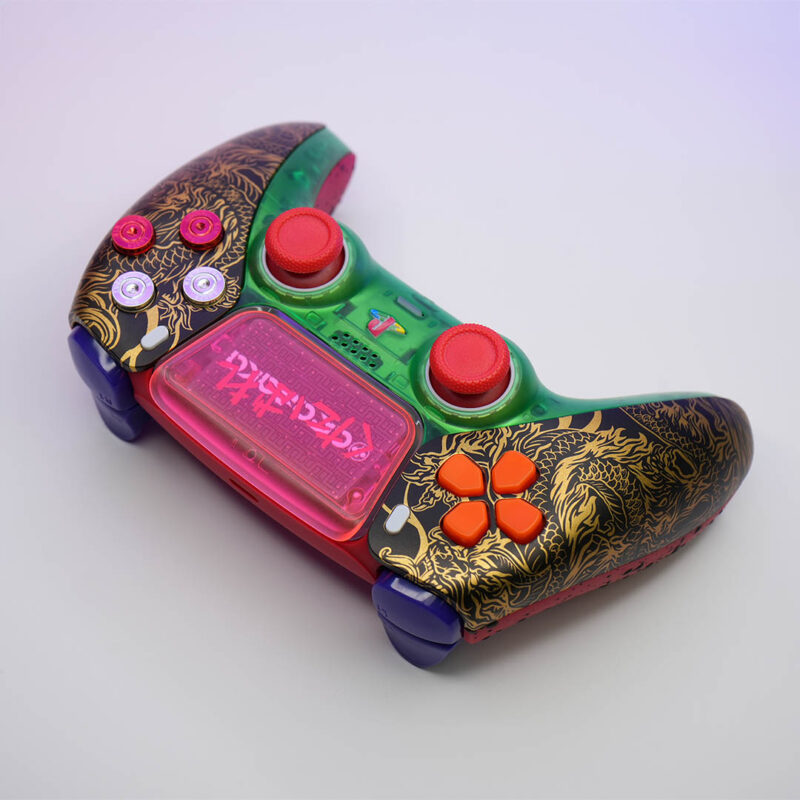 Oni Drive TGR-X PS5 DualSense Controller by Killscreen—featuring a neon green shell, red thumbsticks, a pink touchpad with graffiti-style Japanese text, and gold dragon artwork inspired by the Tyger Claws from Cyberpunk 2077.