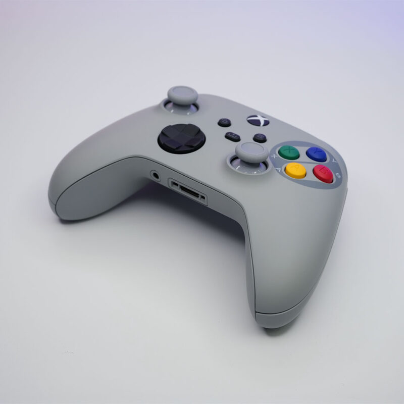 Custom SNES-style Xbox Series X|S controller lying flat, showcasing its slim profile and button placement.