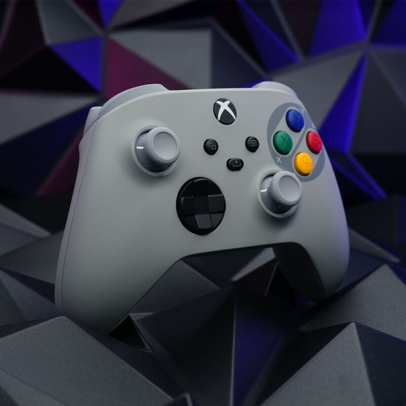 Custom SNES-inspired Xbox Series X|S controller, featuring the classic gray and colorful button layout, displayed at a side angle.