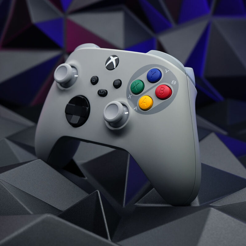 SNES-themed Xbox Series X|S controller with a gray shell and Super Famicom-style buttons, displayed at an angle to showcase its ergonomic design.