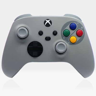 SNES-inspired Xbox Series X|S controller featuring a gray shell with Super Famicom-style red, blue, green, and yellow buttons, displayed on a clean white background.